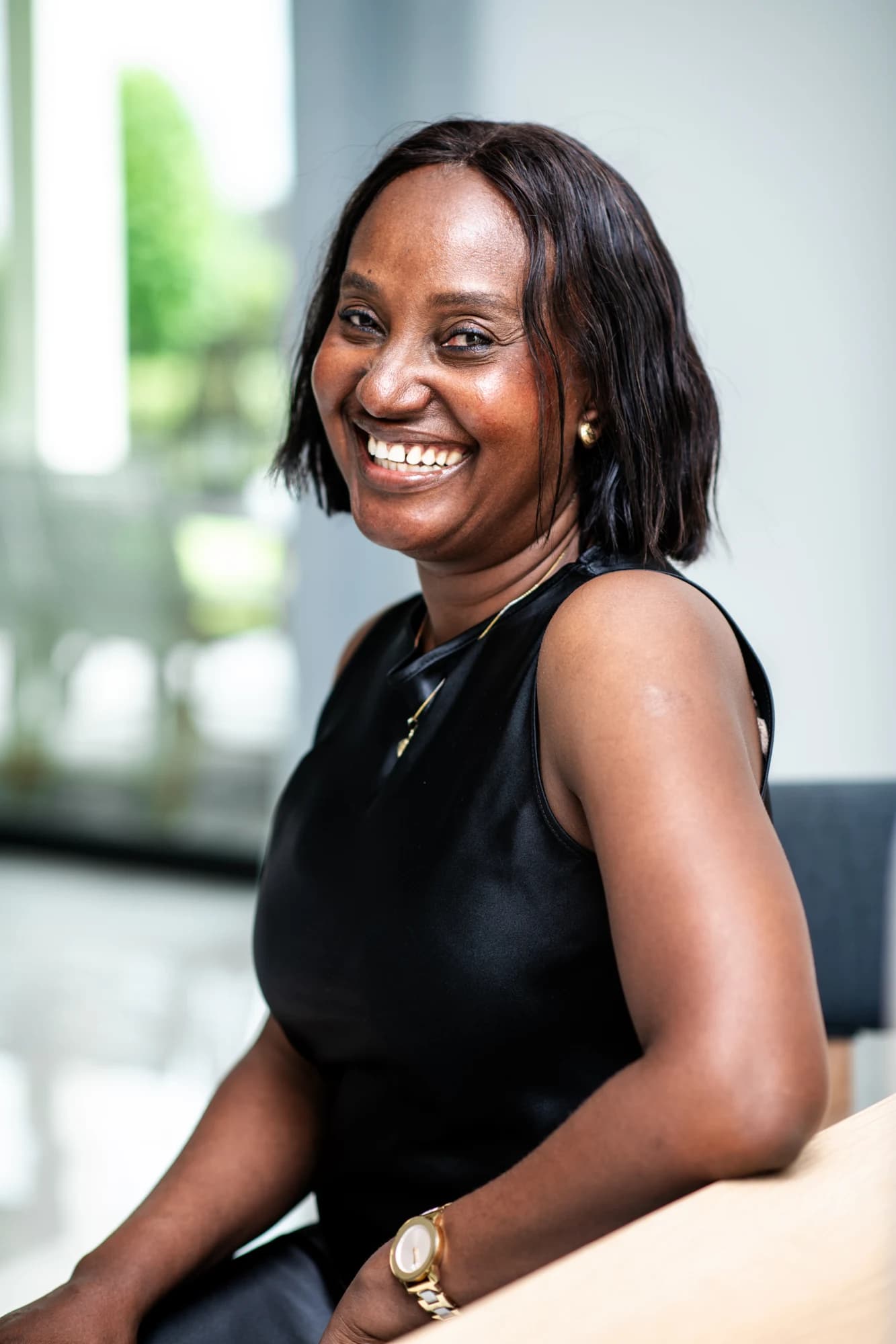 Esther Atere smiling in a bright home interior
