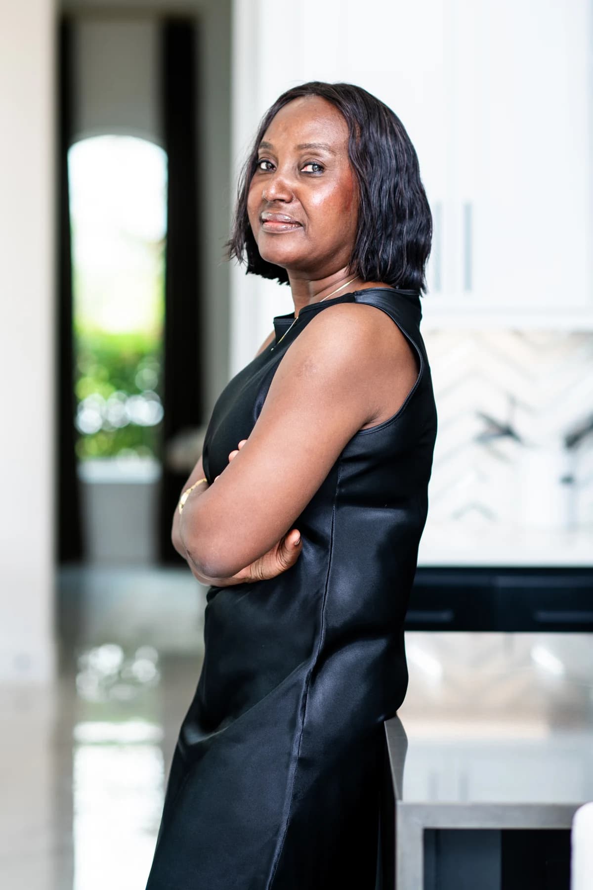 Esther Atere standing with her arms folded in a home interior