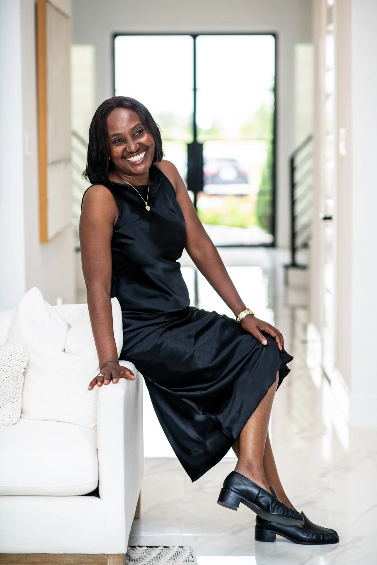 Esther Atere seated in a bright modern living room